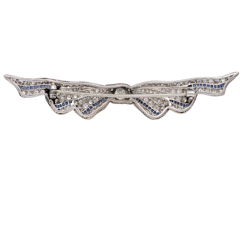 3 Carat Diamond and Sapphire Art Deco Ribbon Platinum Brooch. Circa 1930